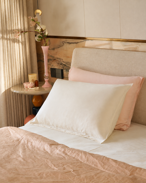 Calora Glide Pillowcase set in Pearl and Blush on a styled bed