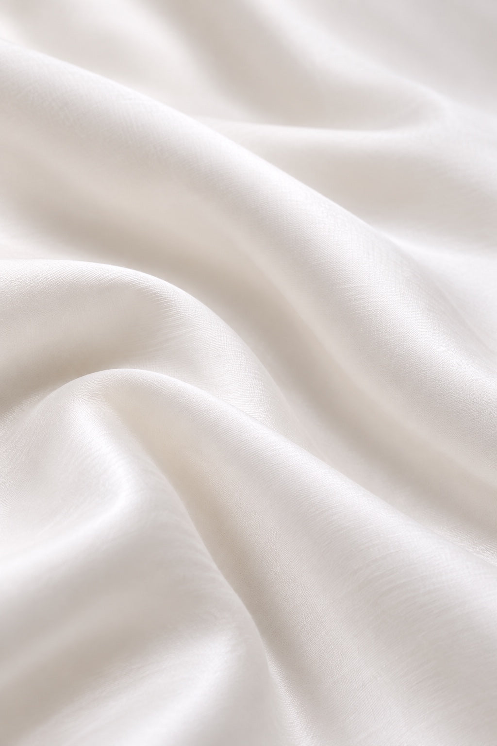 Soft ivory fabric with fine texture and gentle folds.